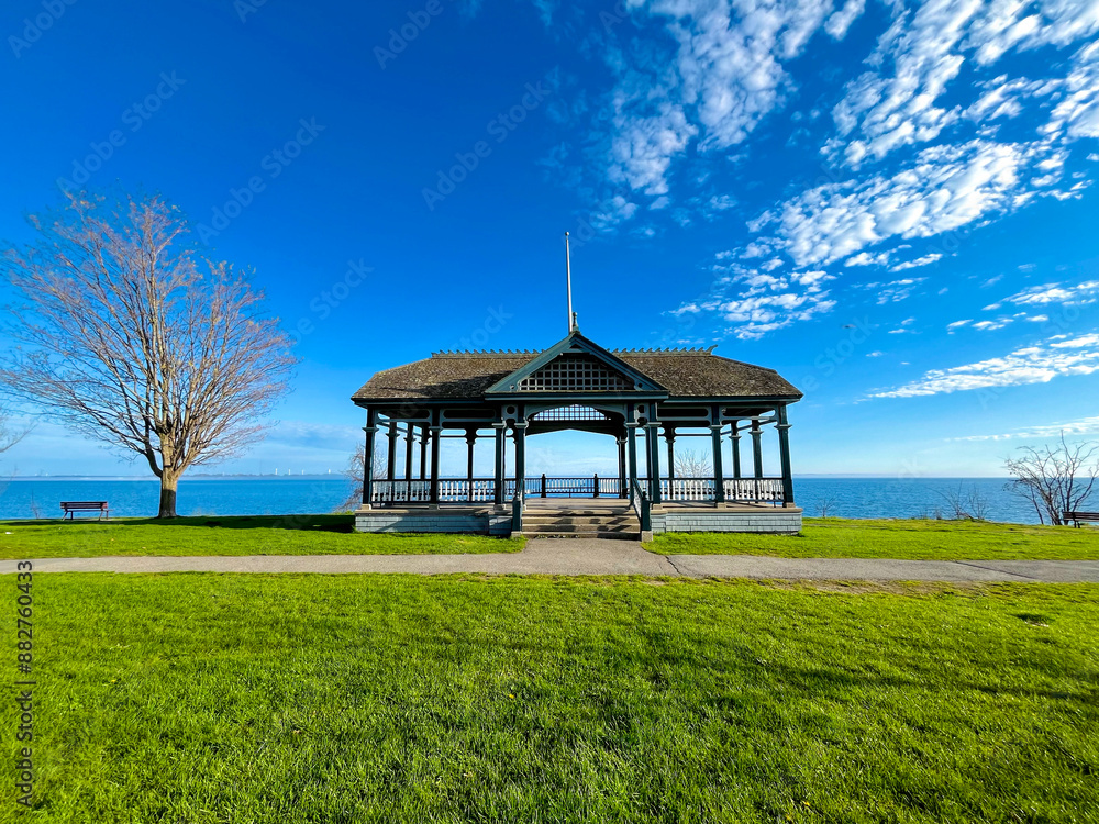 Charming Gazebo by Lake Ontario with Clear Blue Sky and Green Lawn in Kingston, Ontario, Canada Charming Gazebo by Lake Ontario with Clear Blue Sky and Green Lawn in Kingston, Ontario, Canada