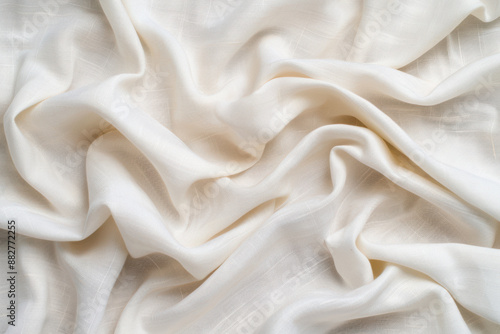 Close-up of elegant white silk fabric with soft, flowing drapes and delicate texture. Ideal for backgrounds, textiles, and fashion-related content.