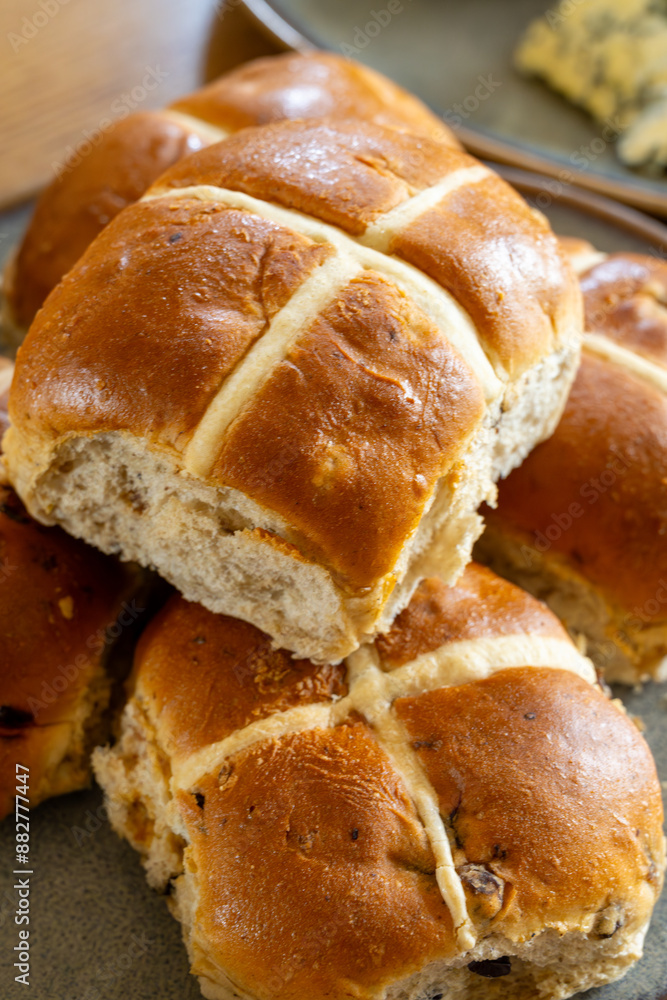 Traditional British Easter food, fresh baked cross buns with raisins or apples Traditional British Easter food, fresh baked cross buns with raisins or apples
