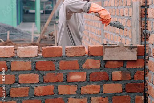 Workers are cementing bricks on a baguna with bricks in the background and shovels in hand, lampung utara, Indonesia 10 Juni 2024 photo