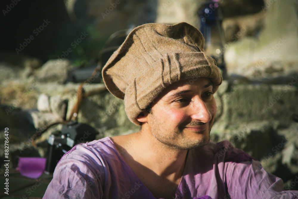 Emotional Portrait close up. A male mercenary of Arab appearance in old clothes and a hat smiles. Satisfaction. Historical reconstruction. Scientific approach Emotional Portrait close up. A male mercenary of Arab appearance in old clothes and a hat smiles. Satisfaction. Historical reconstruction. Scientific approach
