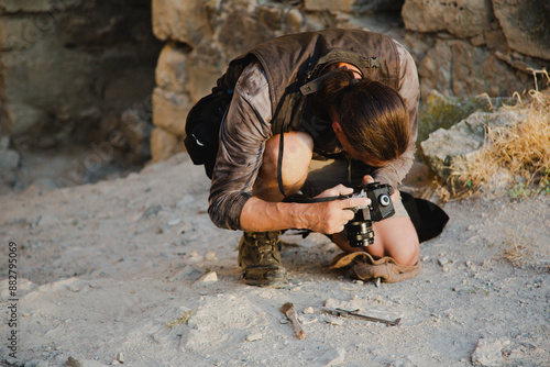 Concept for a history channel. An archaeologist takes a photo of a found artifact photo