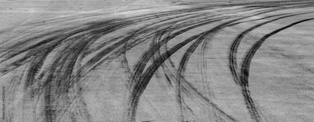 Aerial view Textured background vehicle trace on asphalt road, Tire print texture background transport, Car tire mark burnout texture and background, Tire mark on the asphalt road race track.
