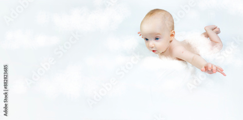 Obraz na płótnie a baby with a hemangioma on his neck lies on a white background. banner with a copy space. pspread arms. the concept of flight w salonie