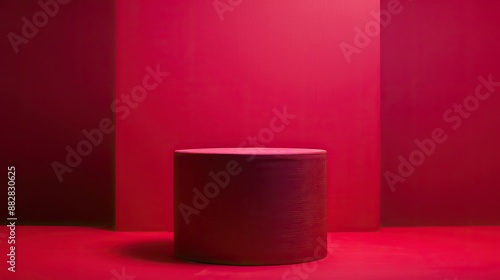 Sophisticated red fabric-covered cylinder podium, magenta backdrop, product showcase