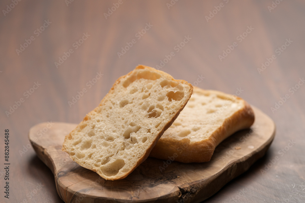 sliced ciabatta bun on wood board closeup sliced ciabatta bun on wood board closeup