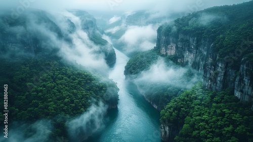 Aerial photo of Guizhou Canyon,The camera looks down a little,The misty morning,The river flows in between two steep cliffs that have been carved by nature into walls,A little further awayï¼Œ the sun 