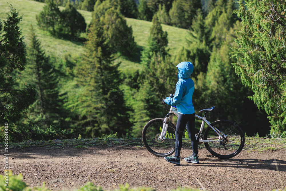 Woman riding mountain bike in forest mountain Woman riding mountain bike in forest mountain