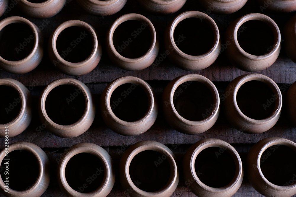 A potter crafts earthenware pottery on clay in Pune, India. A potter crafts earthenware pottery on clay in Pune, India.