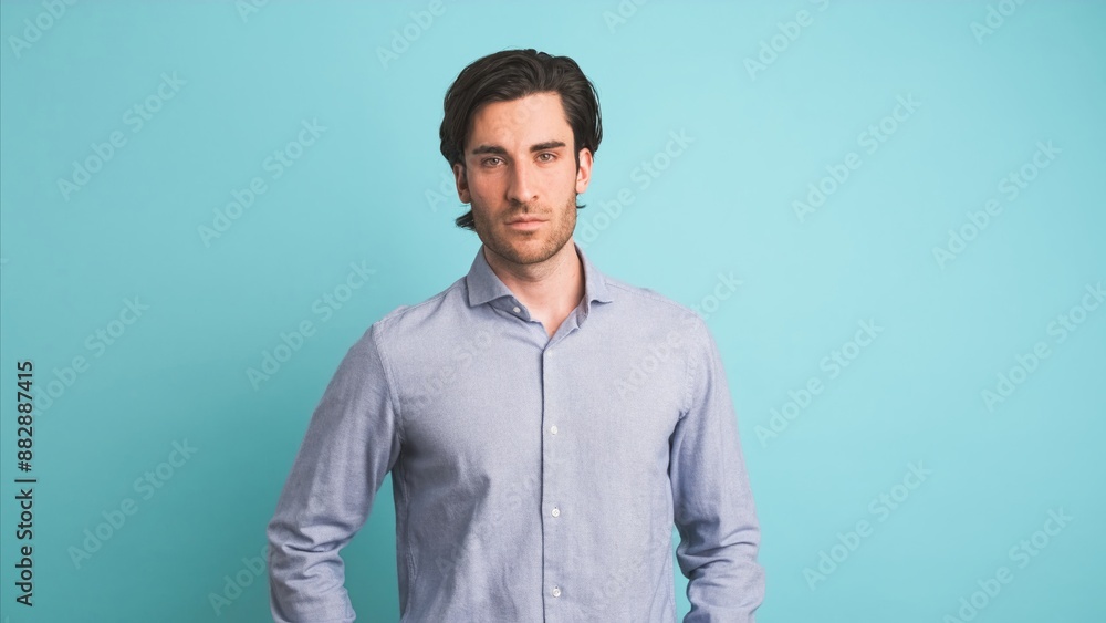 Serious man looking at camera in blue studio Serious man looking at camera in blue studio