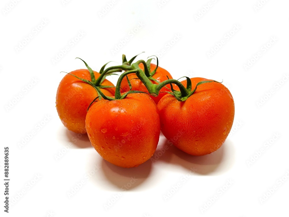 Bunch of fresh, red tomatoes with green stems isolated on white background. Clipping path. Bunch of fresh, red tomatoes with green stems isolated on white background. Clipping path.