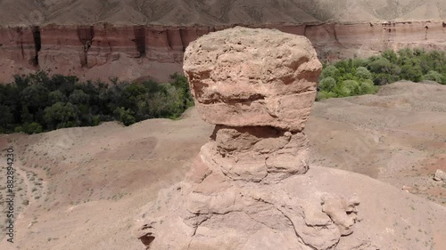 Majestic red rocks of the Temirlik Canyon in Kazakhstan. Sandy rocks eroding due to erosion. Flying over the canyon photo