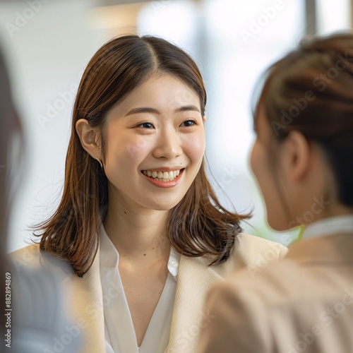 A Japanese woman smiling and talking to her friends 