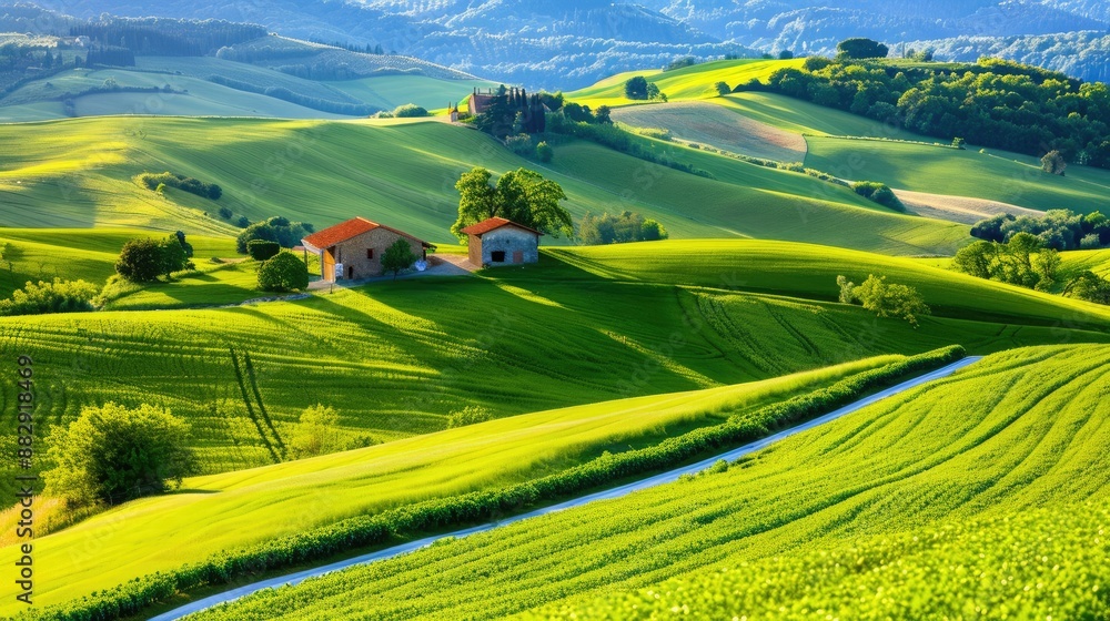 Obraz premium Scenic landscape of rolling green hills and a farmhouse with a vibrant sky in the background, depicting countryside tranquility and natural beauty.