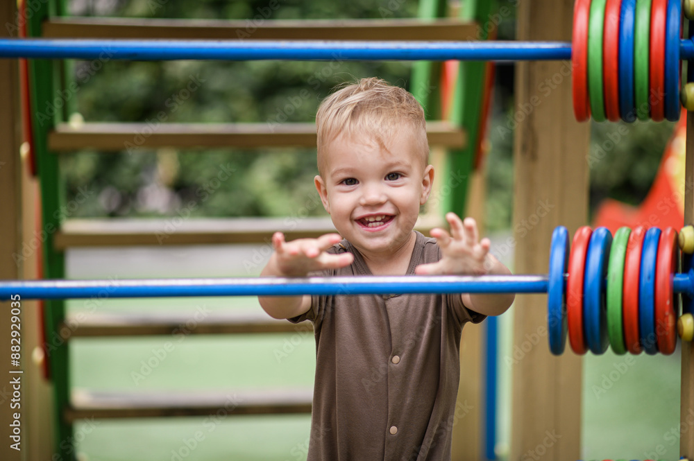 Little boy on the playground in summer Little boy on the playground in summer