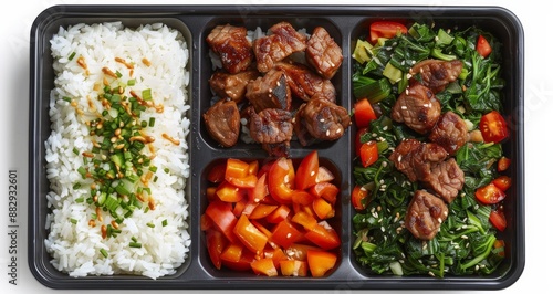 Delicious Lunch Meal With Seared Meat, Rice, and Vegetables in a Black Plasti...