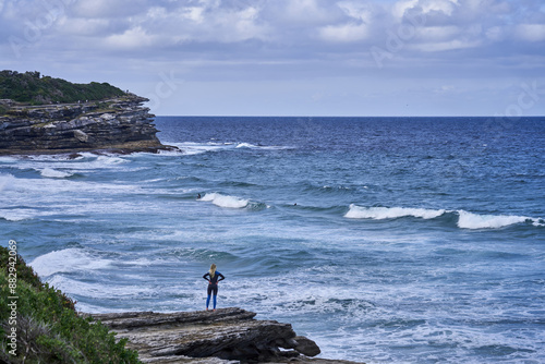 Photography Bondi Beach, Sydney, Australia - June 4, 2023: High angle view of a female surfe