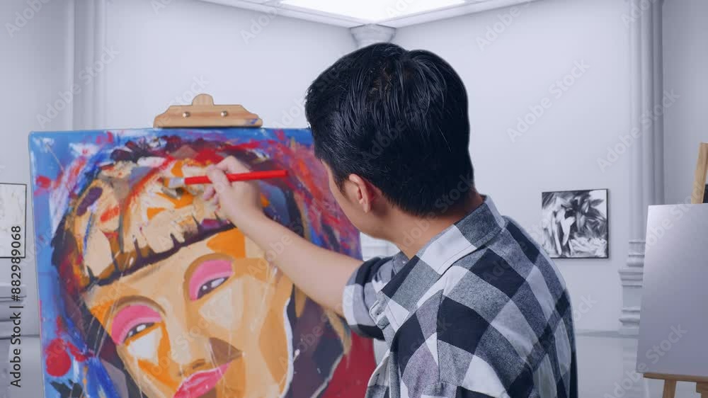 Close Up Back View Of Asian Male Artist Thinking Over Picture Concept While Painting A Girl On The Canvas By Oil Paints And Brush In Gallery Close Up Back View Of Asian Male Artist Thinking Over Picture Concept While Painting A Girl On The Canvas By Oil Paints And Brush In Gallery