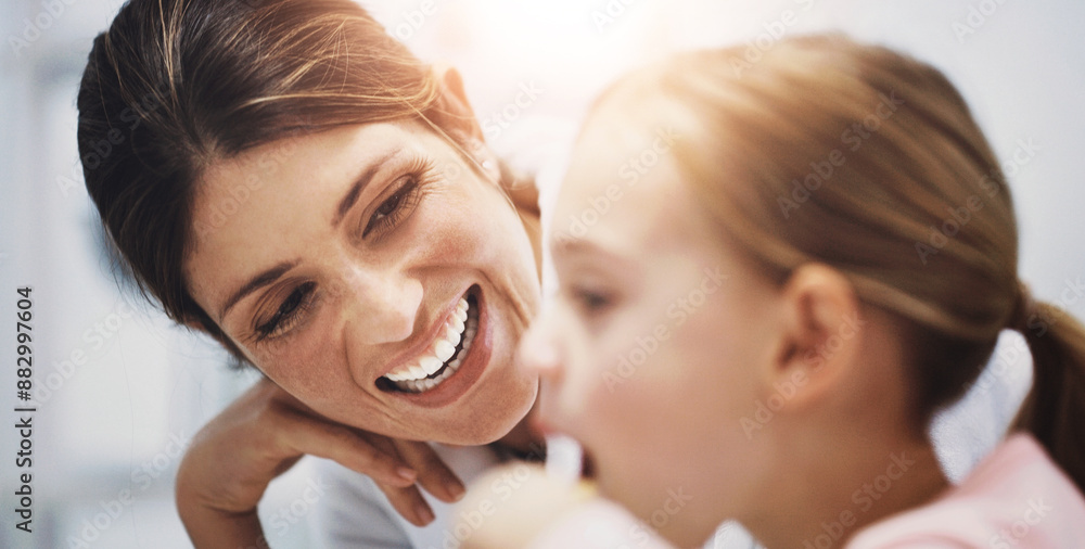 Mother, child and brushing teeth in home bathroom, teaching and oral hygiene with girl for wellness with family. Dental health, cleaning and fresh for breath, routine and plaque prevention in morning Mother, child and brushing teeth in home bathroom, teaching and oral hygiene with girl for wellness with family. Dental health, cleaning and fresh for breath, routine and plaque prevention in morning