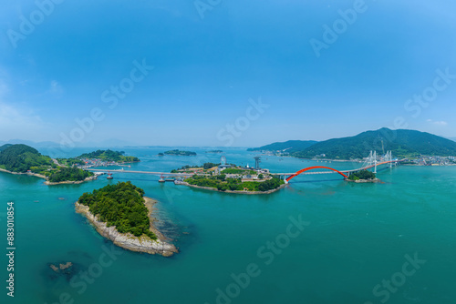 Neopdo-dong, Sacheon-si, Gyeongsangnam-do, South Korea - June 17, 2023: Aerial view of Hakseom and Neungdo Island with Neungdo Bridge and Choyang Bridge on the sea
 photo