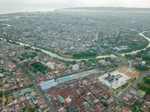 Aerial drone view of big city scenery with Masjid Raya Baiturrahman in Banda Aceh, Aceh, Indonesia. photo