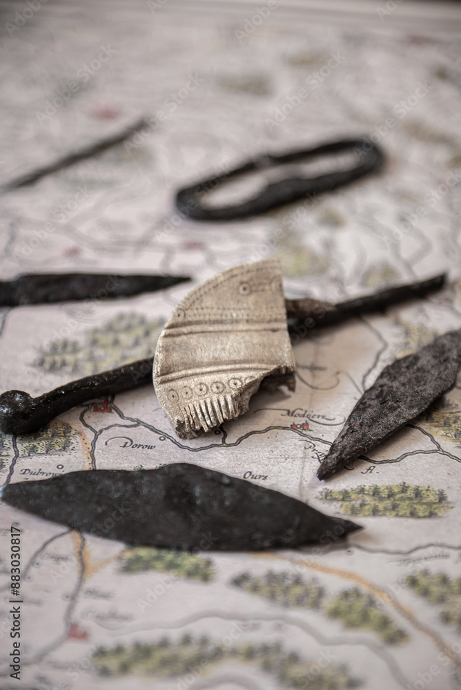 Part of a bone comb (comb) from the 1st-3rd century AD with patterns. Vulture culture. against the background of other old iron things.