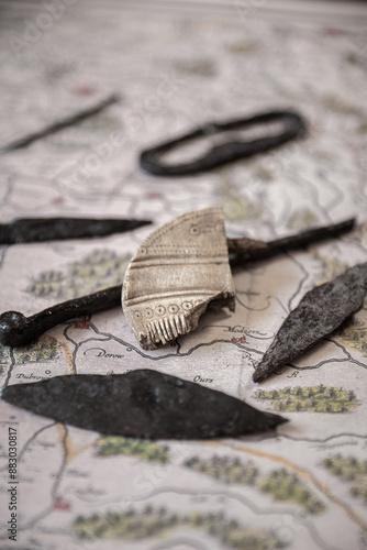Obraz na płótnie Part of a bone comb (comb) from the 1st-3rd century AD with patterns. Vulture culture. against the background of other old iron things. w salonie