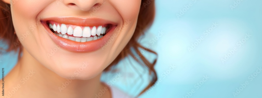Fototapeta premium Close up of smiling woman with beautiful teeth on blue background