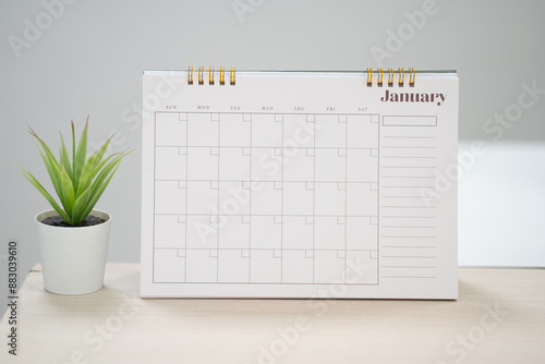 Desk calendar for January  on the table with copy space concept. photo