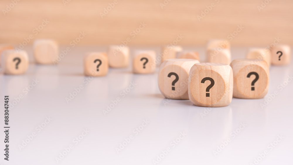 three wooden blocks with question marks over a gray background with copy space three wooden blocks with question marks over a gray background with copy space