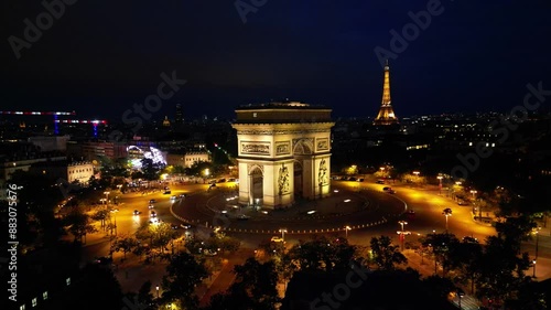 Paris, Arc de Triomphe Triumphal Arch at Chaps Elysees at night, Paris, France. Drone view, Eiffel Tower in the background.  Architecture and landmarks of Paris. Postcard of Paris
