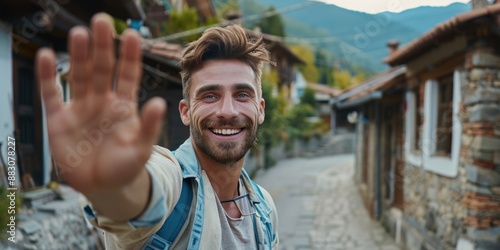 A person holding a makeshift stop sign while traveling or on the move, possibly in an outdoor setting photo