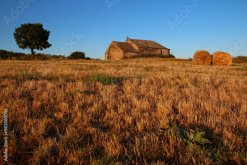 The chapel of Saint Amans and surrounding fields in the last rays of the sun on a July day (Hérault, Occitanie, France)

 photo