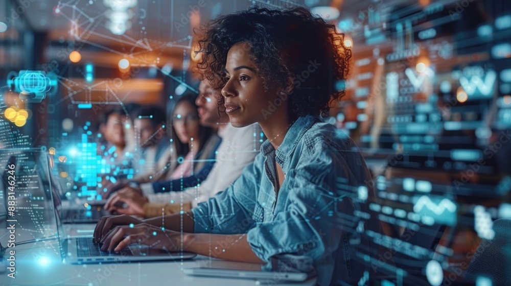A woman sits at a desk in a modern office at night, typing on a laptop A woman sits at a desk in a modern office at night, typing on a laptop