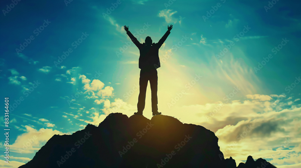 Man standing on a mountain top with arms raised. Man standing on a mountain top with arms raised.