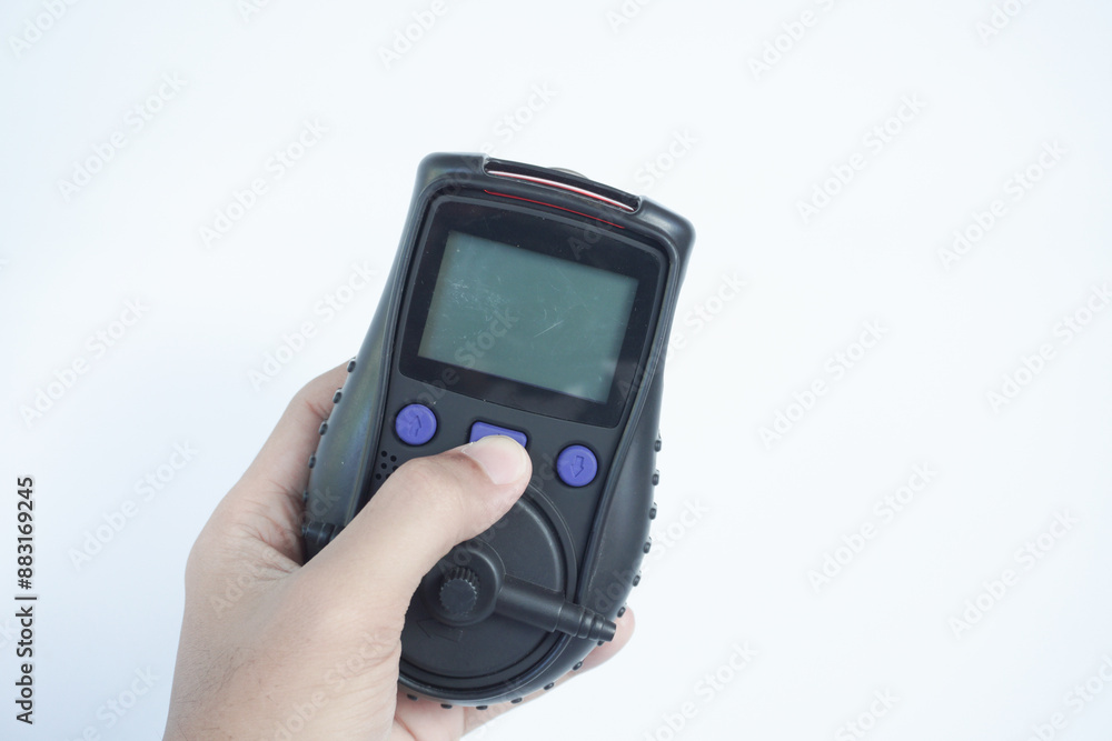 Human's hand holding the Portable Gas Detector for detect combustible gas , flammable gas , toxic gas and oxygen depletion in a confined spaces before starting work. Human's hand holding the Portable Gas Detector for detect combustible gas , flammable gas , toxic gas and oxygen depletion in a confined spaces before starting work.