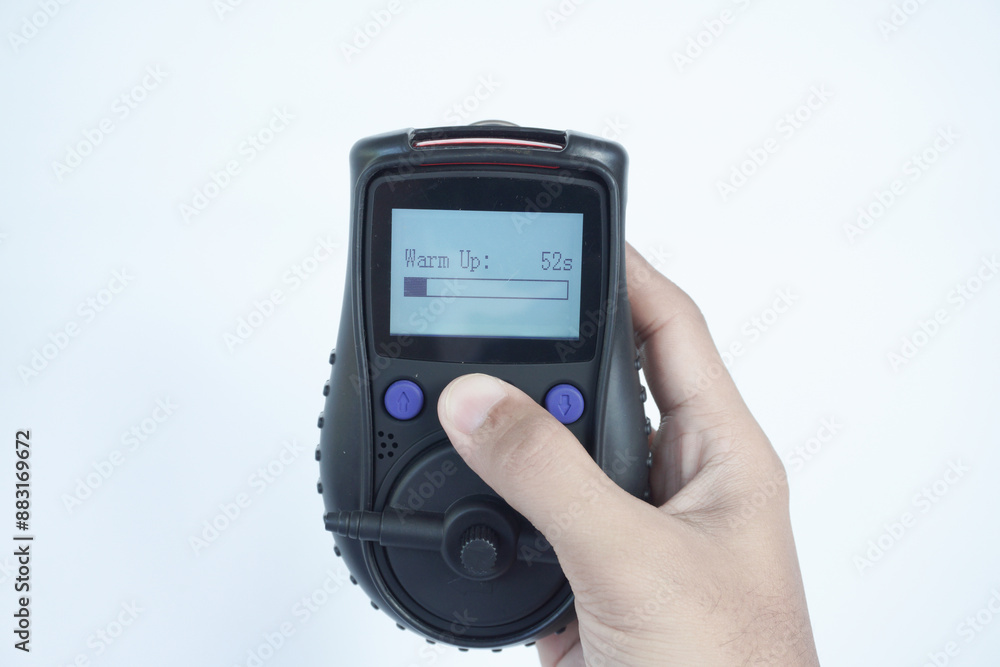 Human's hand holding the Portable Gas Detector for detect combustible gas , flammable gas , toxic gas and oxygen depletion in a confined spaces before starting work. Human's hand holding the Portable Gas Detector for detect combustible gas , flammable gas , toxic gas and oxygen depletion in a confined spaces before starting work.
