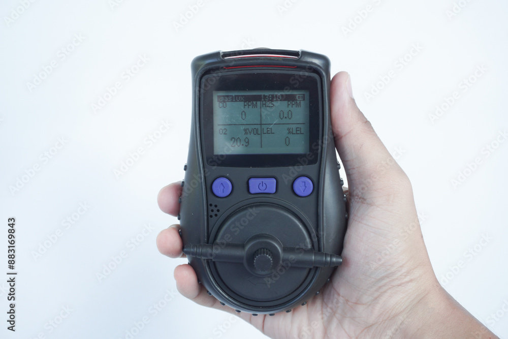 Human's hand holding the Portable Gas Detector for detect combustible gas , flammable gas , toxic gas and oxygen depletion in a confined spaces before starting work. Human's hand holding the Portable Gas Detector for detect combustible gas , flammable gas , toxic gas and oxygen depletion in a confined spaces before starting work.