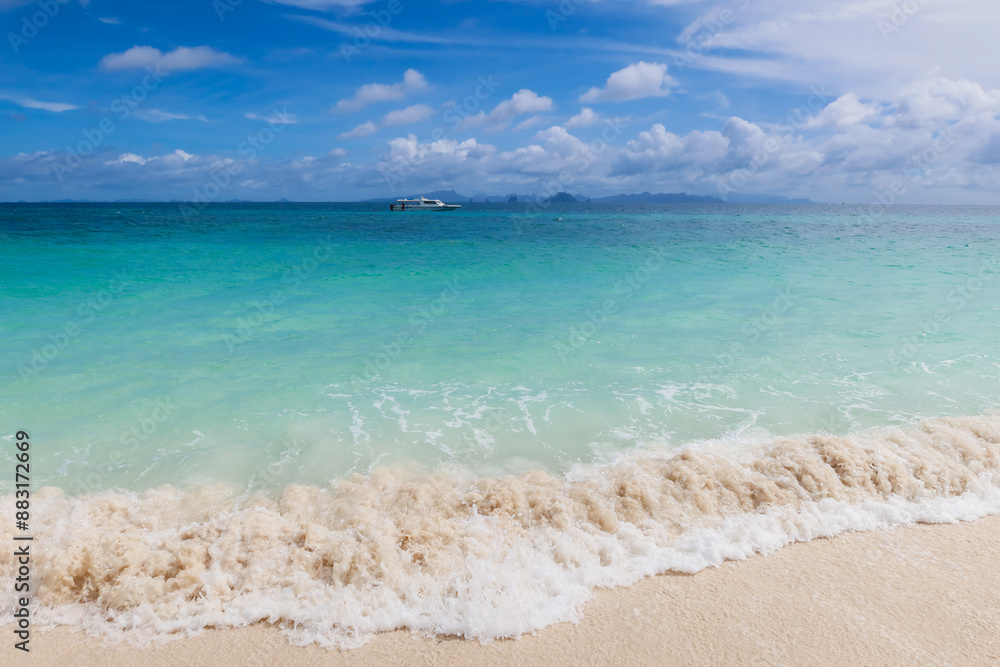 Beautiful beach with white sand, turquoise ocean water and blue sky with clouds in sunny day. Panoramic view. Natural background for summer vacation. Empty sea with blue sky on summer at Thailand. Beautiful beach with white sand, turquoise ocean water and blue sky with clouds in sunny day. Panoramic view. Natural background for summer vacation. Empty sea with blue sky on summer at Thailand.