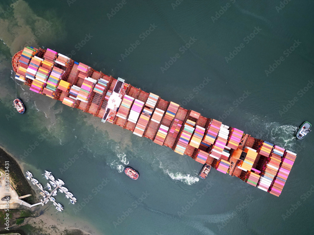 Fototapeta premium Aerial top view container ship full load container for logistics import, export, shipping or transportation concept background.