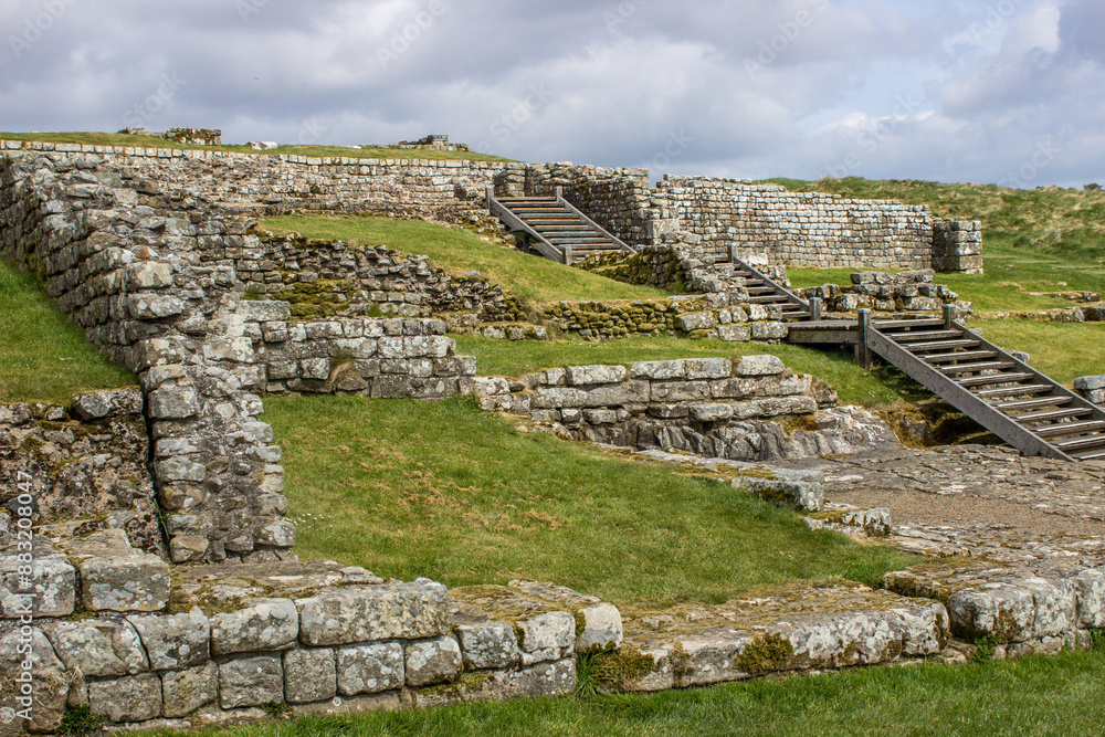 Looking out over the ruins of the barracks at Housestead fort, a Roman Fort along Hadrians Wall in Northumberland National Park, Northern England. Looking out over the ruins of the barracks at Housestead fort, a Roman Fort along Hadrians Wall in Northumberland National Park, Northern England.