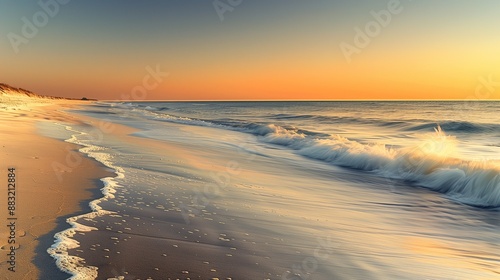 A tranquil beach at dusk, with soft, golden sand, gentle waves lapping at the shore, and the sky transitioning from orange to deep blue as the sun sets.