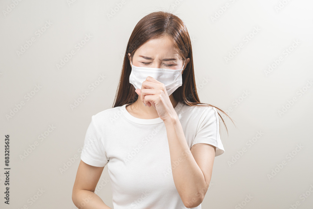 Unhealthy sickness, unwell asian young woman wearing mask coughing, have sore throat, suffering symptom cough feeling bad and healthcare of air pollution and dust, PM2.5 isolated white background. Unhealthy sickness, unwell asian young woman wearing mask coughing, have sore throat, suffering symptom cough feeling bad and healthcare of air pollution and dust, PM2.5 isolated white background.