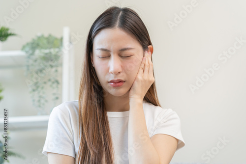 Tinnitus concept, sick asian young woman, girl have ear pain or earache, hand touch plug ear, suffering painful otitis from loud of noisy sound, inflammation. Health care nerve deaf eardrum disease.