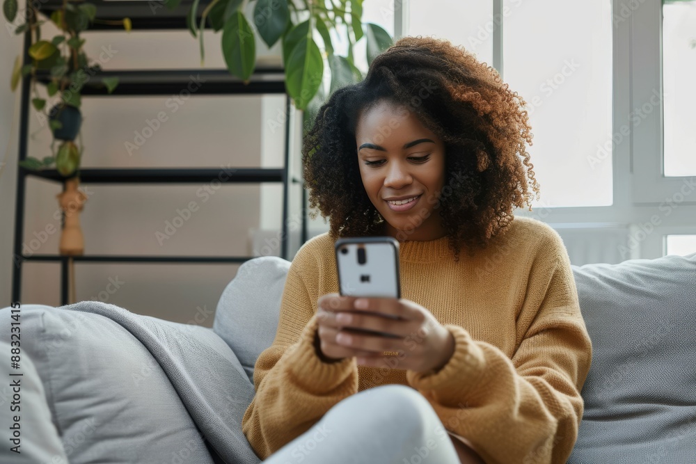 black woman with smartphone on a sofa for networking online, mobile app or relax chat with home wifi. young person on couch using phone for internet, social media post or email communication update black woman with smartphone on a sofa for networking online, mobile app or relax chat with home wifi. young person on couch using phone for internet, social media post or email communication update