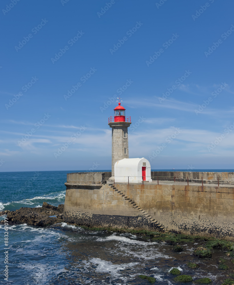 Maritime landscape. Porto landmark, Portugal. Seascape with big wave crashes at the lighthouse Maritime landscape. Porto landmark, Portugal. Seascape with big wave crashes at the lighthouse