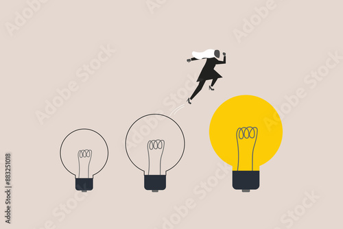 Business woman jumping on bigger lightbulb, successfully. concept of goal, achievement, advancement in career or business growth concept. Aspiration and motivation