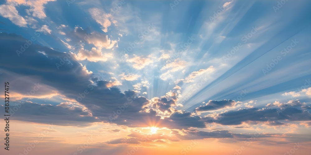 Obraz premium Sun sets behind vibrant clouds casting dramatic rays in the sky. Concept Nature, Sunset, Clouds, Sky, Landscape