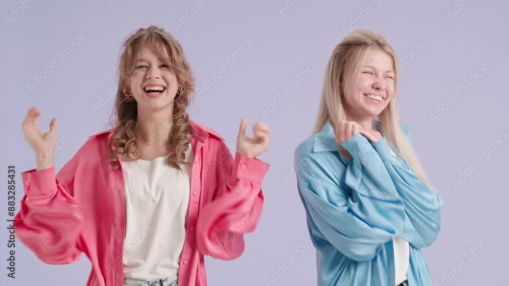 Young stylish women models show wow amazed expression and happy joyful emotions, isolated on purple background. Fashion and youth beauty concept. Young stylish women models show wow amazed expression and happy joyful emotions, isolated on purple background. Fashion and youth beauty concept.