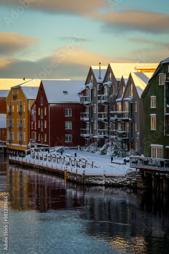 Colorful old wooden houses with reflections in the river Nidelva in the Brygge district of Trondheim, Norway